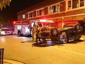 Windsor Firefighters, Windsor Police and EMS Paramedics work the scene of a rollover accident on Drouillard Road at Whelpton Street in Windsor, Ontario on September 15, 2015. (JASON KRYK/The Windsor Star)