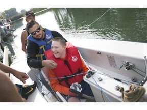 Jaden Powell, 12, is all smiles after getting into a Martin 16 sailboat with his step-father, Aaron Pratt, for the Adaptive Sailing Event at the Mariners Yacht Club, Saturday, Sept. 26, 2015.  The event, now in it's fourth year, provides people with physical or intellectual challenges an opportunity to sail in specifically designed sailboats.  (DAX MELMER/The Windsor Star)