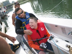 Jaden Powell, 12, is all smiles after getting into a Martin 16 sailboat with his step-father, Aaron Pratt, for the Adaptive Sailing Event at the Mariners Yacht Club, Saturday, Sept. 26, 2015.  The event, now in it's fourth year, provides people with physical or intellectual challenges an opportunity to sail in specifically designed sailboats.  (DAX MELMER/The Windsor Star)