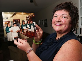 Kathy Cote reminisces about her family's restaurant, the Station Lunch. For five decades, the Pelletier Street diner run by the Paul and Mary Dragicevic was a gathering place for the west-end neighbourhood. A reunion for former patrons is set for Sept. 26 at Average Joes on Lauzon Road. Cote poses with her wedding photo on Thursday, September 17, 2015. It was a taken with her mother and sisters in November of 1986.  (DAN JANISSE/The Windsor Star)