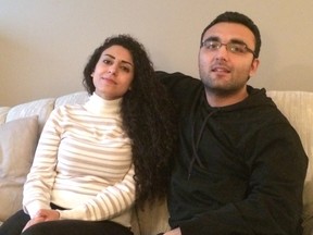 Syrian refugees Mohmmed Darweesh, right, and Reem Younes discuss the threats they faced in their homeland and their journey to their new home in Winnipeg, Man., on Thursday, September 10, 2015. The couple were sponsored by a church and a non-profit group and have settled into a new life in the Manitoba capital. THE CANADIAN PRESS/Steve Lambert