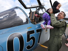 The Top Gun Kids with Cancer Take Flight event was held Saturday, Sept. 12, 2015, at the Windsor Airport. David Whittal, deputy chief pilot with Discovery Air Defence gives Avaleigh Stradeski, 2, a close up look at the Alpha jet.  (DAN JANISSE/The Windsor Star)