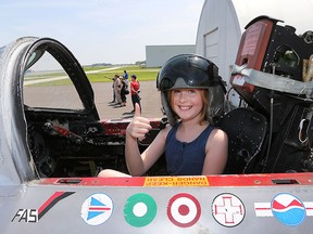 Maya Hulme, 10, a participant in the Top Guns Kids with Cancer Take Flight event is shown at the Canadian Historical Aircraft Association in Windsor, ON. on Friday, July 10, 2015 sitting in the T-33 Silver Star. (DAN JANISSE/The Windsor Star)