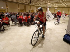 Kathie Houle and Angelo Magri ride their bikes into the hall during the United Way kickoff at the Ciociaro Club in Tecumseh on Tuesday, September 15, 2015. The United Way has set a target of $7.5 million for this years campaign.                               (TYLER BROWNBRIDGE/The Windsor Star)