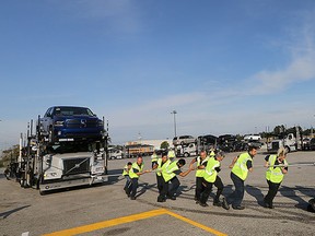 The Tough Truck Pull for United Way event which has teams of 15 people pulling a tractor trailer loaded with RAM trucks and weighing 85,000 pounds is quickly approaching. The event place on Sept. 20, 2015, on Riverside Drive in front of the Chrysler Building. A team from Laval International demonstrates how it's done on Friday, Sept. 11, 2015. (DAN JANISSE/The Windsor Star)