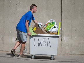 A UWSA volunteer helps students move in to residences at the University of Windsor, Sunday, Sept. 6, 2015.  (DAX MELMER/The Windsor Star)