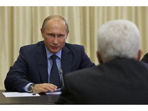 FILE - In this Sept. 22, 2015, file photo, Russian President Vladimir Putin meets with Palestinian President Mahmoud Abbas, right, in Novo-Ogaryovo residence outside Moscow. Face-to-face for the first time in nearly a year, President Barack Obama and Putin on Monday, Sept. 28, will confront rising tensions over Moscow's military engagement in Syria, as well as the stubborn crisis in Ukraine.