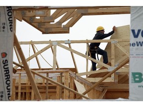 A framing crew works on a new home in Windsor on July 8, 2015.                         (TYLER BROWNBRIDGE/The Windsor Star)