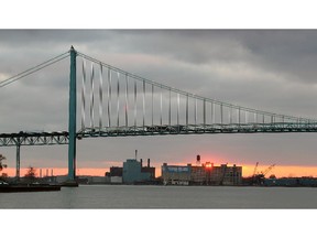 The sun sets west of the Ambassador Bridge Nov. 6, 2012.