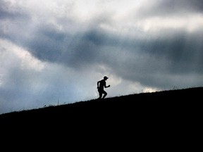 A silhouetted runner exercises in Malden Park in this file photo.