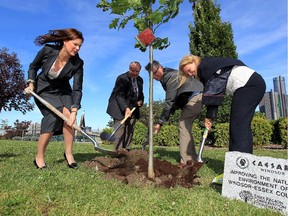 Susan Stockwell Andrews, left, president of Essex Region Conservation Foundation, Ed Sleiman, city councillor, Richard Wyma, exec. director Essex Region Conservation Foundation and Kelly Wolfe Gregoire, right, VP human resources Caesars Windsor, participate in a tree-planting ceremony at Riverfront Festival Plaza. Caesars Windsor donated $30,000 to the Foundation's community fundraising events September 30, 2015.