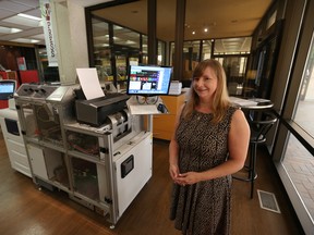 Sue Perry from the Windsor Public Library operates the Espresso Book Machine at the main branch in downtown Windsor, Ontario on Sept. 1, 2015. The Espresso Book Machine allows library customers to print custom books while they wait.  (JASON KRYK/The Windsor Star)