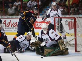 Windsor Spitfires goaltender Michael Giugovaz makes a save during action against the  Erie Otters  in the Ontario Hockey League opening game at the WFCU Centre in Windsor, Ontario on September 24, 2015. (JASON KRYK/The Windsor Star)