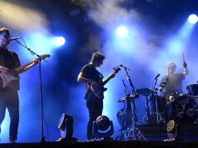 Joe Newman, left, and Gus Unger-Hamilton, centre, of the British band alt-J perform during the Rock-en-Seine music festival in Saint-Cloud near Paris on Aug. 30, 2015. The band will be in Detroit on Sept. 22 to perform at the Meadow Brook Music Festival. (BERTRAND GUAY / AFP / Getty Images)