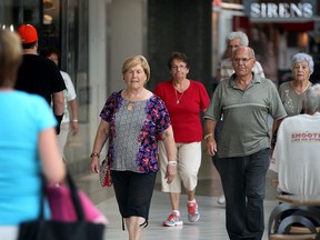 Devonshire Mall walkers Flora Carlini, left, Bianca Pizzuti, and Bob Smilev, centre right, lead a group of seniors around the food court on Tuesday, Sept. 1. (NICK BRANCACCIO / The Windsor Star)