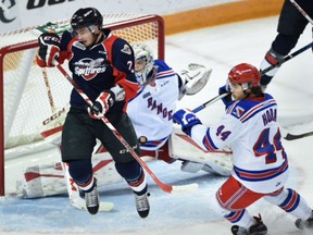 Kitchener, Ontario - 15-10-09 - News -Kitchener Rangers Frank Hora, right, watches as Logan Stanley of the Windsor Spitfires deflects a shot in front of goalie Luke Opilka in first period OHL action at The Aud,  Friday.  Mathew McCarthy, Record staff