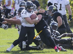 Windsor's Cody McCann tries to break free from a tackle during OFC action between the visiting GTA Grizzlies and the AKO Fratmen at E. J. Lajeunesse, Saturday, Oct. 10, 2015.  (DAX MELMER/The Windsor Star)