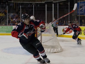 Spits forward Luke Kirwan, left, chases a loose puck with Anthony Stefano in the background Saturday against the Otters in Erie, Pa. (Sarah Skelton/Erie Otters)