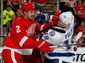 Brendan Smith #2 of the Detroit Red Wings gets a glove in the face of Ondrej Palat #18 of the Tampa Bay Lightning during the second period of Game Six of the Eastern Conference Quarterfinals during the 2015 NHL Stanley Cup Playoffs at Joe Louis Arena on April 27, 2015 in Detroit, Michigan. (Photo by Gregory Shamus/Getty Images)