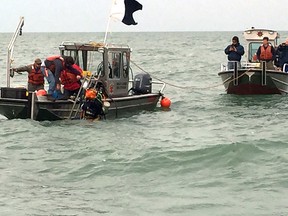 Contractors conduct dive operations at the site of a sunken barge near the Kelley's Island Shoal in Lake Erie, Oct. 21, 2015.  The divers were trying to establish the identity of the barge and if it or any of its cargo poses an environmental threat.