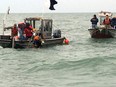 Contractors conduct dive operations at the site of a sunken barge near the Kelley's Island Shoal in Lake Erie, Oct. 21, 2015.  The divers were trying to establish the identity of the barge and if it or any of its cargo poses an environmental threat.