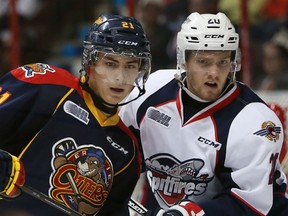 Erie Otters Patrick Fellows and Windsor Spitfires Andrew Burns fight for position during the Ontario Hockey League opening game against the Erie Otters at the WFCU Centre in Windsor, Ontario on September 24, 2015. (JASON KRYK/The Windsor Star)