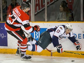 Tecumseh's Sam Studnicka, left, checks Anthony Stefano into the boards  at TD Place Arena in Ottawa. (Wayne Cuddington/Ottawa Citizen)