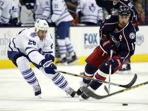 Columbus Blue Jackets' Brandon Dubinsky, right, works for the puck against Toronto Maple Leafs' Daniel Winnik during the second period of an NHL hockey game in Columbus, Ohio, Friday, Oct. 16, 2015. (AP Photo/Paul Vernon)