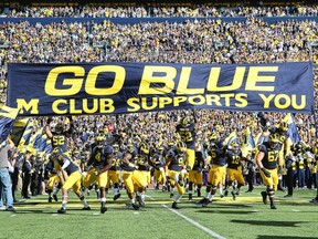The Michigan Wolverines enter the field prior to the start of the game against the Northwestern Wildcats on October 10, 2015 at Michigan Stadium in Ann Arbor, Michigan. The Wolverines defeated the Wildcats 38-0. (Photo by Leon Halip/Getty Images)