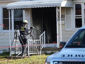 An investigator with the Ontario Marshal's Office probes a Balfour Boulevard fire scene on Oct. 26, 2015.