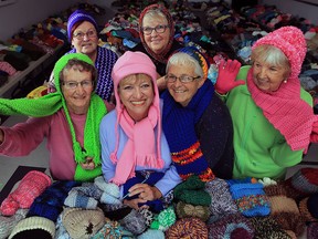 Knitting club from Solidarity Towers pose with some of their 2,559 sets of wool hats, scarves and mittens which will be donated to needy families across the area. Vera Keane, left, Val Taylor, Carrol D'Agnolo, Joyce Muldoon, right, along with Carol Renaud, back left and Lynn Robertson, back right, used their time and skill to assemble a roomful of appearal as winter approaches. Windsor Family Credit Union were a financial contributor to the project.