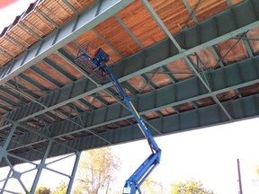 Crews install planks of wood beneath the Ambassador Bridge on Oct. 20, 2015. (Jason Kryk/The Windsor Star)