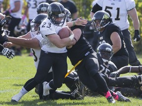 Windsor's Cody McCann tries to break free from a tackle during OFC action between the visiting GTA Grizzlies and the AKO Fratmen at E. J. Lajeunesse, Saturday, Oct. 10, 2015.  (DAX MELMER/The Windsor Star)