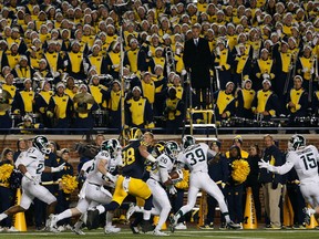Defensive back Jalen Watts-Jackson #20 of the Michigan State Spartans runs the football into to endzone for the game winning touchdown against the Michigan Wolverines during the final seconds of college football game at Michigan Stadium on October 17, 2015 in Ann Arbor, Michigan. The Spartans defeated the Wolverines 27-23. (Photo by Christian Petersen/Getty Images)