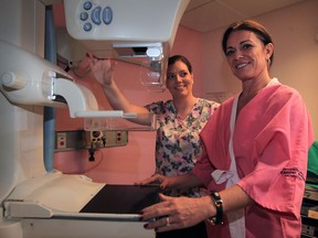 Monica Staley, right, VP, Erie St. Clair Regional Cancer Program, prepares to take her first mammogram with MRT Yolanda Mifflin, left, during Just Book It mammogram campaign at Windsor Regional Hospital Met campus, October 21, 2015. October 21st is the provincial Day of the Mammogram and October is Breast Cancer Awareness Month .  The Just Book It campaign aims to get women 50-54 to sign up for their first mammograms and the entire procedure is less than 10 minutes, which could save a woman's life.