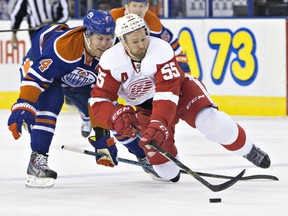 Detroit Red Wings' Niklas Kronwall (55) is tripped by Edmonton Oilers' Taylor Hall (4) during first period NHL action in Edmonton, Alta., on Wednesday October 21, 2015. THE CANADIAN PRESS/Jason Franson