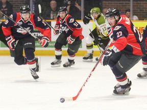 Windsor's Hayden McCool, right, carries the puck against the Battalion in North Bay Thursday. (Dave Dale/North Bay Nugget)