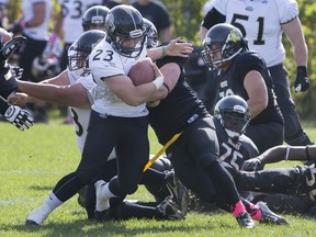 Windsor's Cody McCann tries to break free from a tackle during OFC action between the visiting GTA Grizzlies and the AKO Fratmen at E. J. Lajeunesse, Saturday, Oct. 10, 2015.  (DAX MELMER/The Windsor Star)