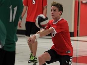 Luke Brouwer, right, of Maranatha Christian Academy sets the ball against Josh Schoberl, left, of Herman Green Griffins at the Maranatha gym Monday October 26, 2015. Thomas Kogel, behind, watches as the play develops.