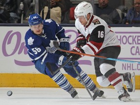 Max Domi #16 of the Arizona Coyotes has the puck knocked away by Byron Froese #56 of the Toronto Maple Leafs during an NHL game at the Air Canada Centre on October 26, 2015 in Toronto, Ontario, Canada. (Photo by Claus Andersen/Getty Images)