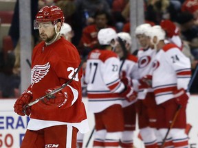 Detroit Red Wings' Tomas Tatar (21), of Slovakia, skates away as the Carolina Hurricanes celebrate a goal by Chris Terry during the third period of an NHL hockey game Friday, Oct. 16, 2015, in Detroit. The Hurricanes defeated the Red Wings 5-3. (AP Photo/Duane Burleson)