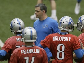 Detroit Lions offensive coordinator Joe Lombardi talks to the quarterbacks during an NFL football organized team activity in Allen Park, Mich., Wednesday, May 28, 2014. (AP Photo/Carlos Osorio)