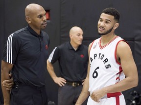 Toronto Raptors coach Jerry Stackhouse, left, speaks with Cory Joseph during the Raptors' media day in Toronto on September 28, 2015. THE CANADIAN PRESS/Darren Calabrese