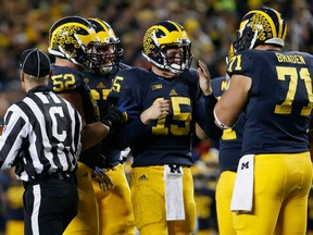 Quarterback Jake Rudock #15 of the Michigan Wolverines reacts after being tackled during the fourth quarter of the college football game against the Michigan State Spartans at Michigan Stadium on October 17, 2015 in Ann Arbor, Michigan.  The Spartans defeated the Wolverines 27-23.  (Photo by Christian Petersen/Getty Images)