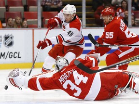 Detroit Red Wings goalie Petr Mrazek (34) stops a shot by Carolina Hurricanes center Victor Rask (49) in the first period of an NHL hockey game Tuesday, Oct. 27, 2015 in Detroit. (AP Photo/Paul Sancya)