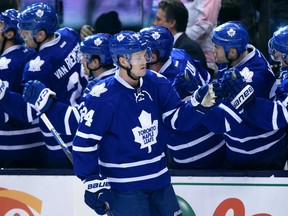Toronto Maple Leafs' Peter Holland receives congratulations from teammates after scoring the game-tying third goal during third period NHL hockey action in Toronto on Saturday, Oct. 10, 2015. THE CANADIAN PRESS/Frank Gunn