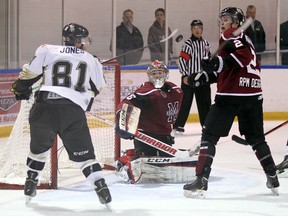 The LaSalle Vipers Blake Jones tries to bat a puck out of the air in front of the Chatham Maroons Connor McKinnon and goaltender Brendan Johnston at the Vollmer Centre in LaSalle on Wednesday, October 28, 2015.                                      (TYLER BROWNBRIDGE/The Windsor Star)