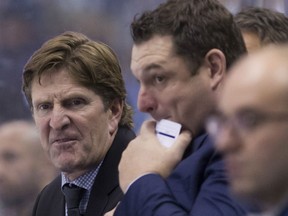 Leafs head coach Mike Babcock, left, and Windsor's D.J. Smith watch the team during a 6-4 loss in Buffalo. THE CANADIAN PRESS/Chris Young