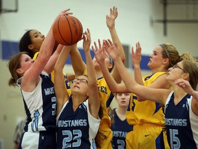 Basketball players from  the St. Anne Saints and Massey Mustangs battle for the basketball during high school action at St. Anne Catholic High School on October 1, 2015. (JASON KRYK/The Windsor Star)