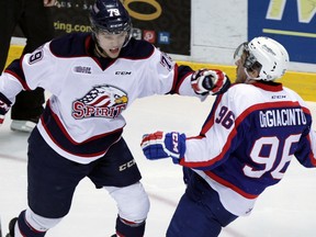 Saginaw Spirit Jacob Ringuette slows down Windsor Spitfires Cristiano DiGiacinto in OHL league action from WFCU Centre Thursday December 18, 2014.   (NICK BRANCACCIO/The Windsor Star)